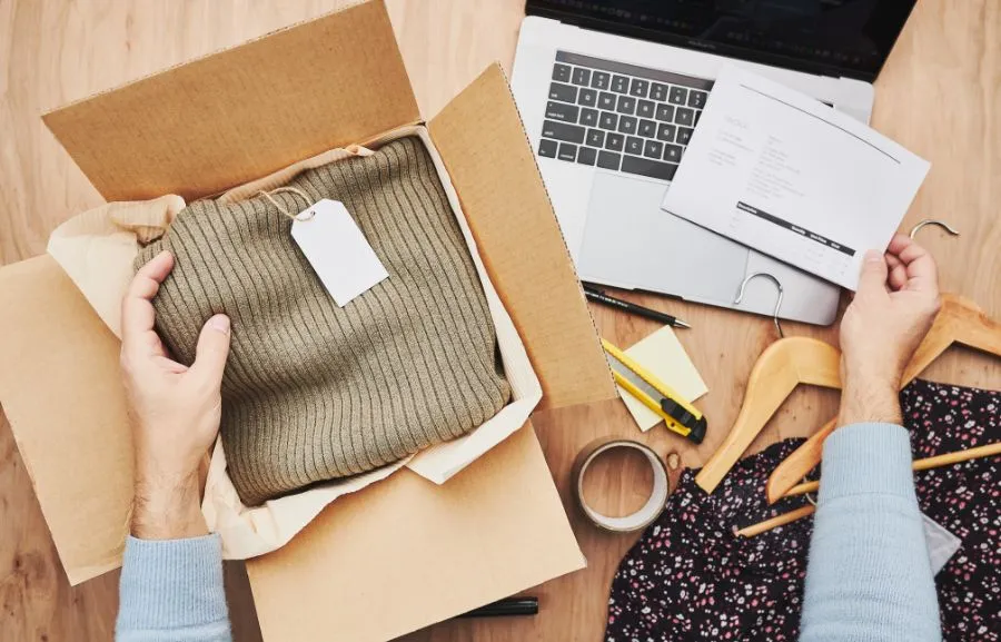 Image showing a Shopify store owner who is holding an order package.